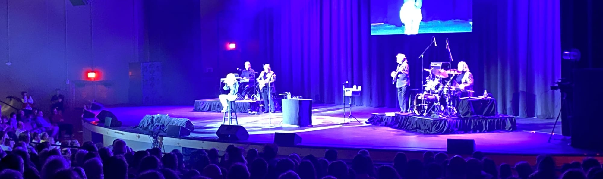 signer on stage in chair washed out by the lights Chicago